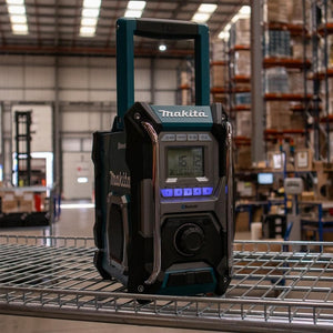Makita radio on a metal rack in a warehouse setting