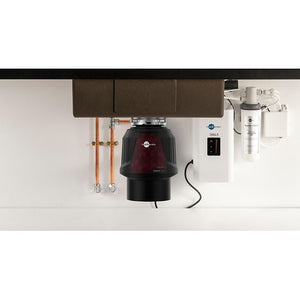 Under-sink kitchen disposal unit with plumbing and electrical components.