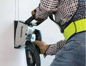 Person using a Makita power tool on a white background