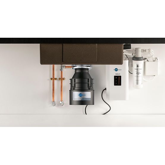 Under-sink plumbing system with a black pump and visible brand logo on a white countertop.